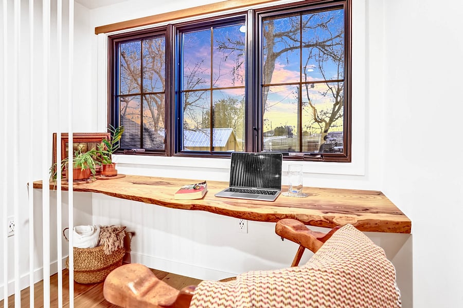 Work area with live-edge wood desk from trees on property, ethernet, and USB plus regular outlets.