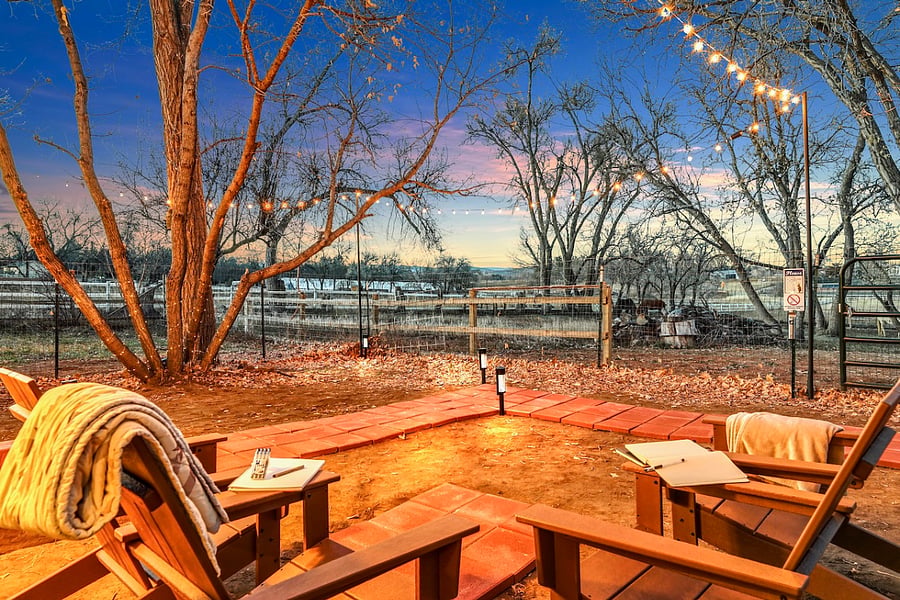Lounge chairs and lights to enjoy your fenced yard free from the pups while overlooking the herd.