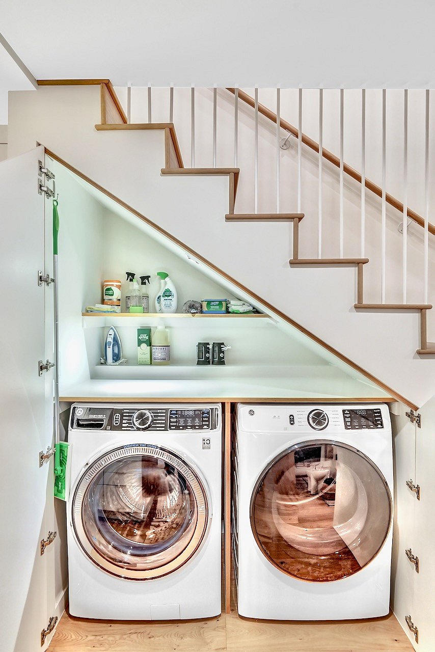 New washer, dryer, and ample cleaning supplies.
