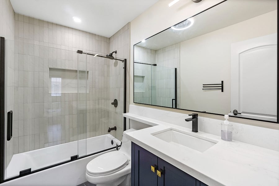 Completely updated guest bathroom with quartz countertops.