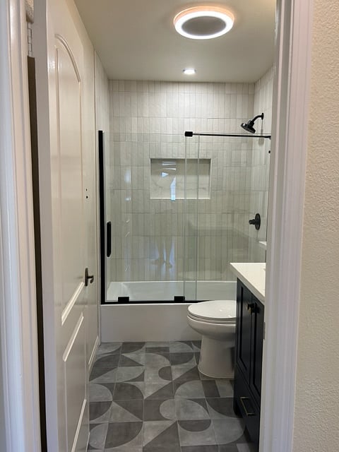 Completely updated guest bathroom with quartz countertops.
