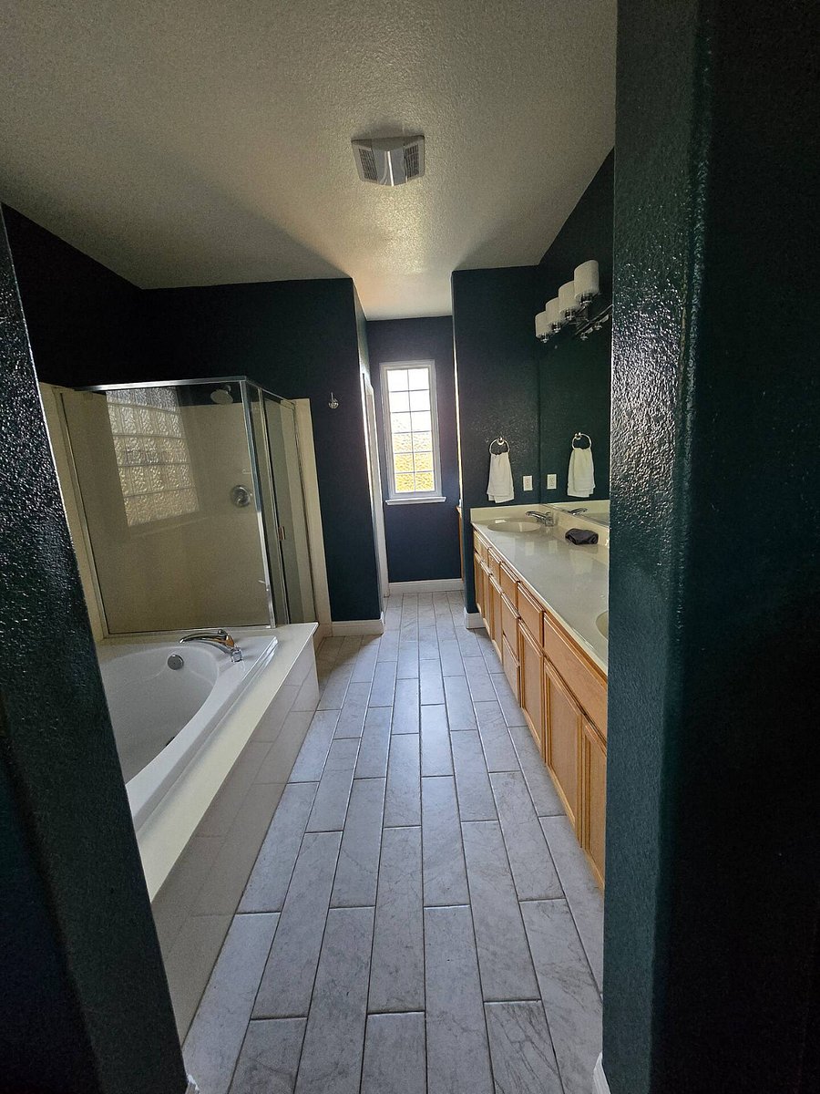 Primary bathroom with soaking tub, shower, double vanity.