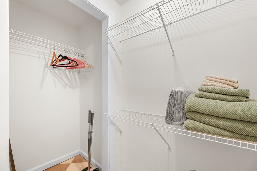 Spacious Closet with hangers, extra towels and laundry basket