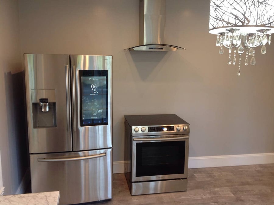 Samsung touch screen refrigerator that connects via wifi and allows you to see your groceries while shopping. With range hood exhaust fan to take away any food fumes while cooking and the flat top Samsung stove