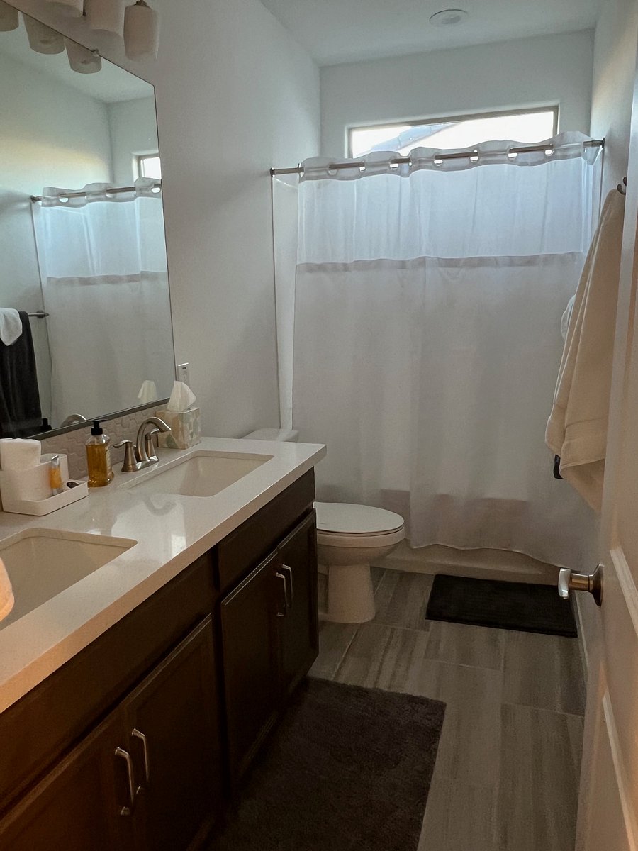 Full bath with dual vanities and shower / tub combo