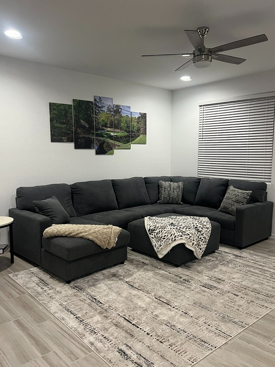 Large U-shaped couch with plenty of pillows and blakets