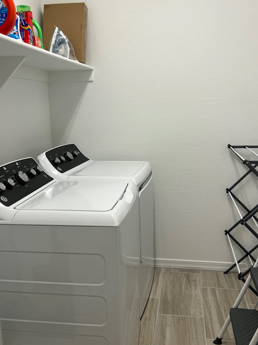 Laundry room with new washer and dryer