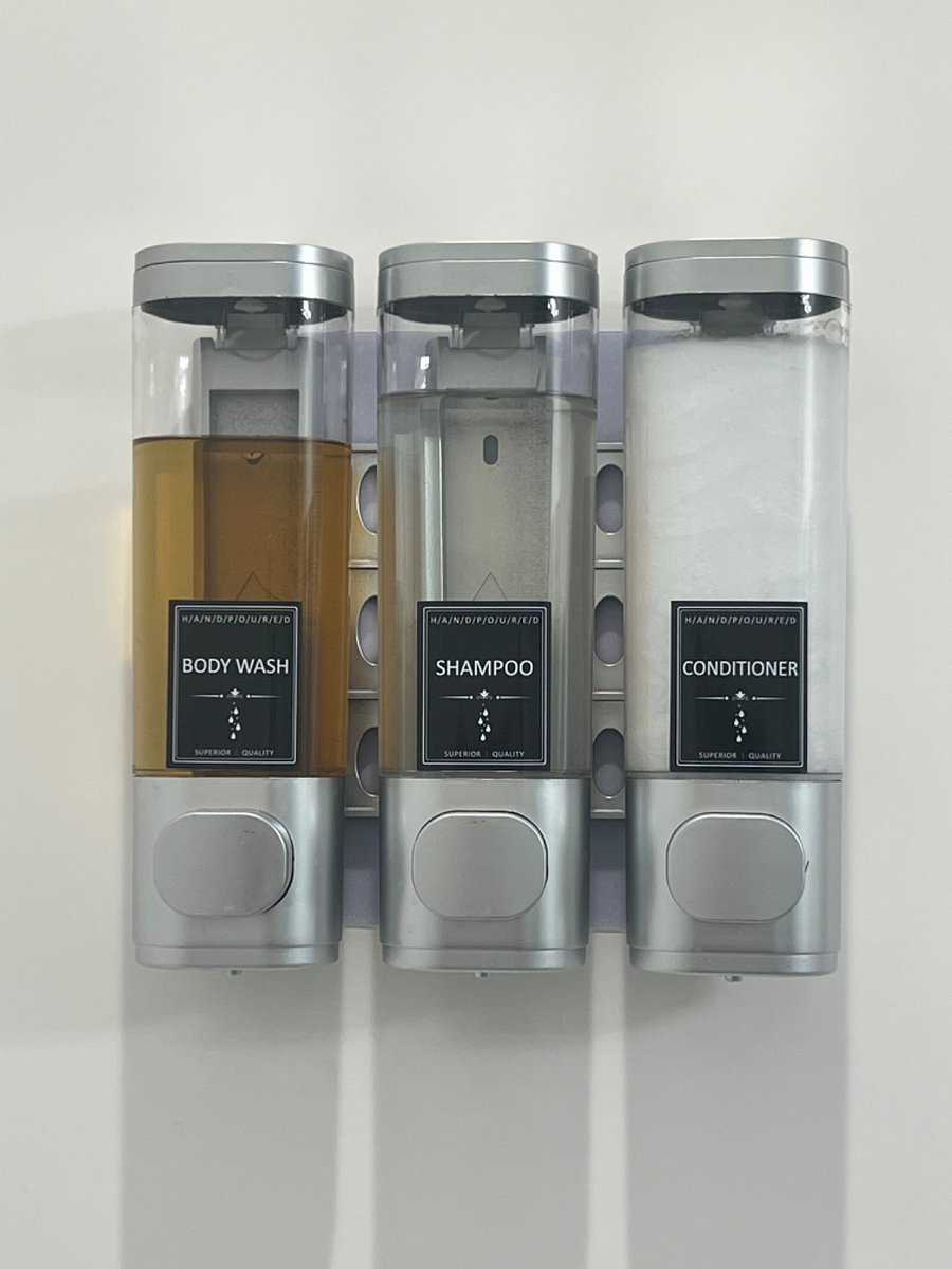 Both showers have wall-mounted shampoo, conditioner, and shower gel