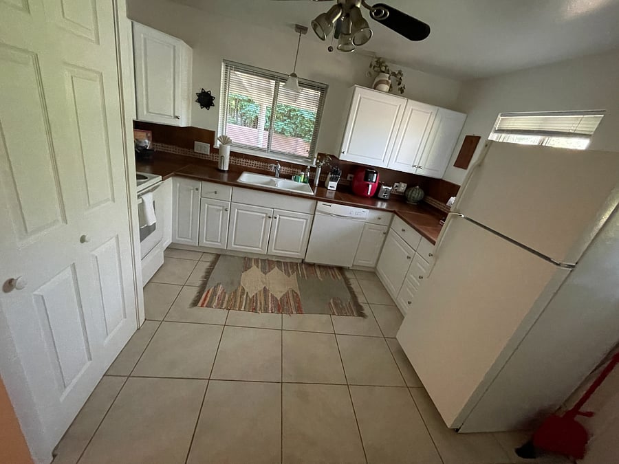 Kitchen features washer-dryer beyond door seen at far left