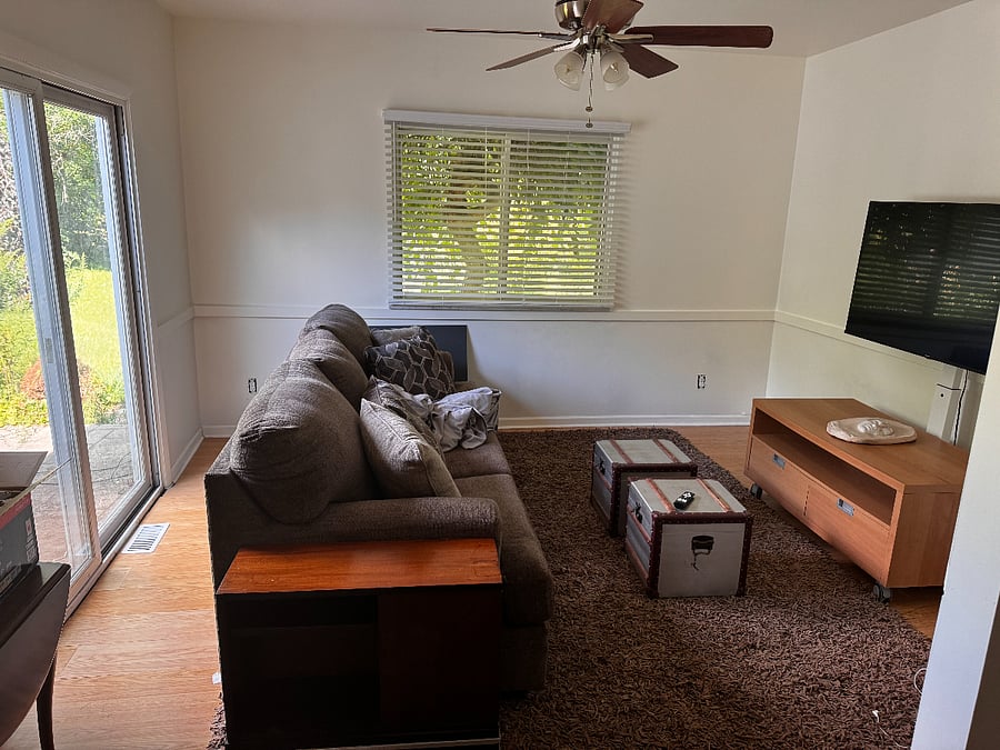 Den with access to backyard.