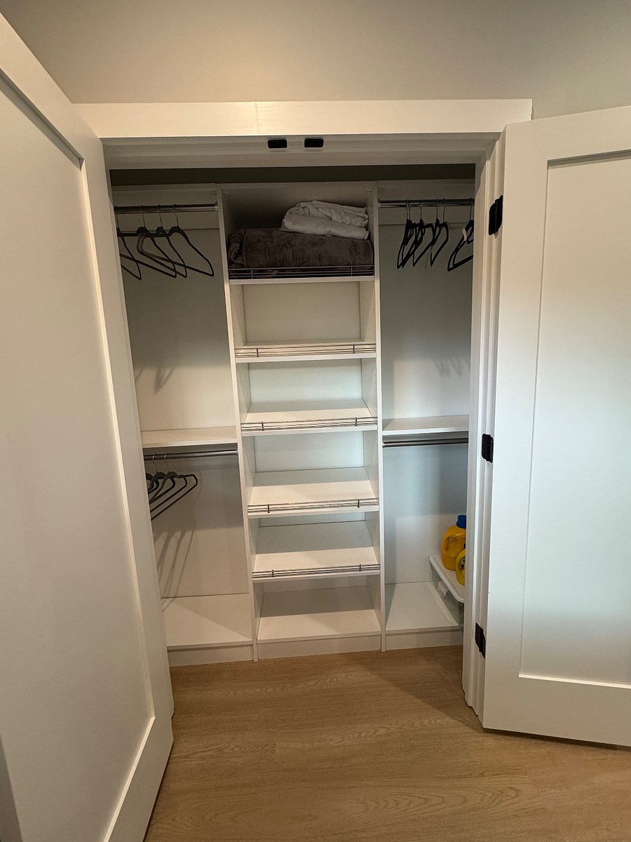 Bedroom closet with ironing board, iron, laundry supplies and automatic blow up queen size air mattress 