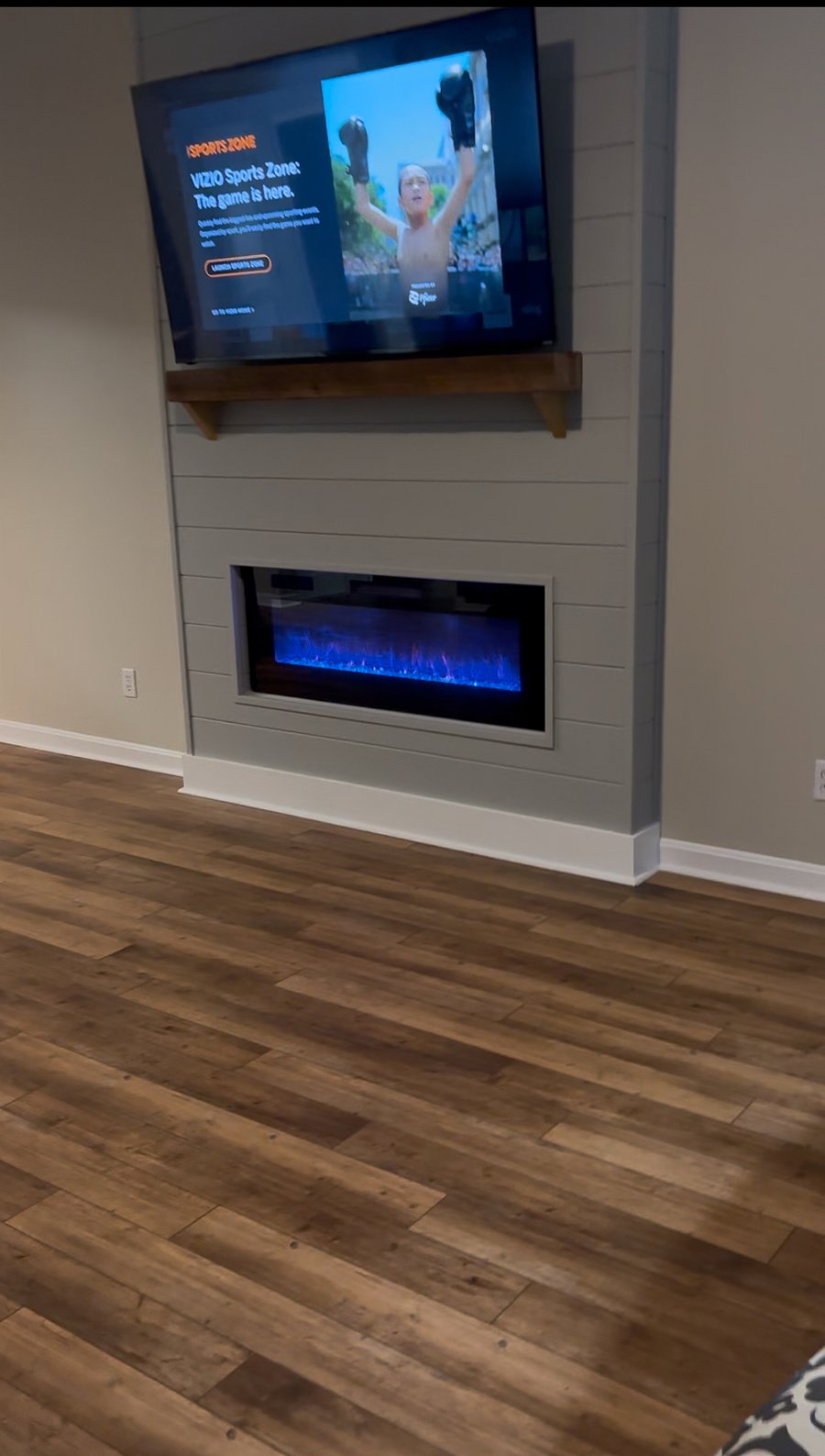 A beautiful electric fireplace and a 75-inch smart TV.