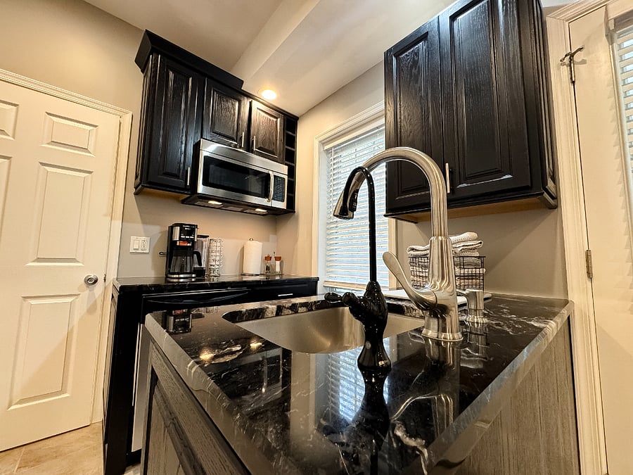 Compact yet efficient kitchen complete with convection microwave and reverse osmosis drinking water system.