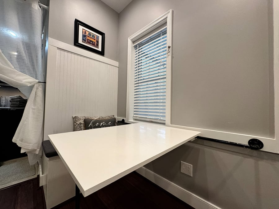 Bench seat with table deployed. Yes it moves in and out based on your preference!