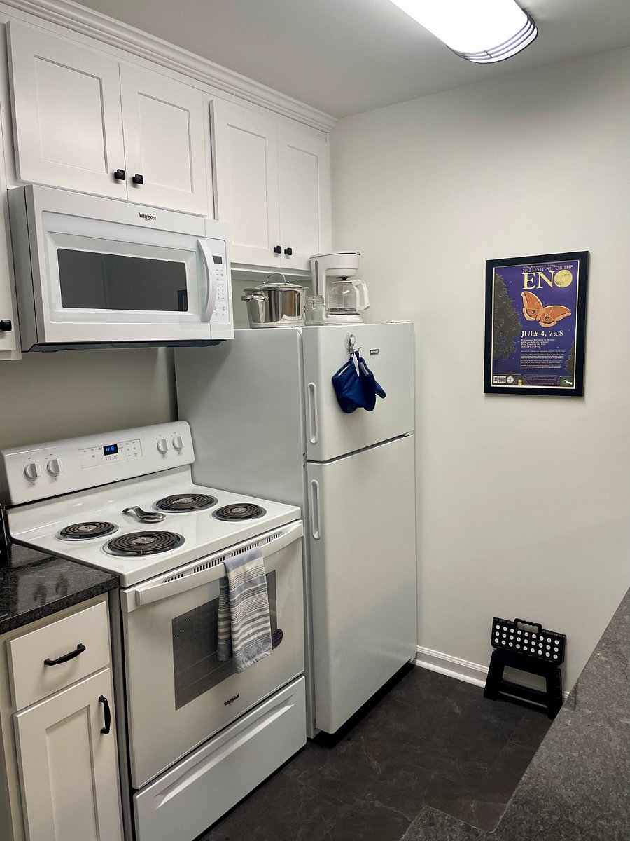 Kitchen with full sized dishwasher, pots, pans, utensils, and basic starter set of selected items, including coffee, tea, sugar, salt and pepper.