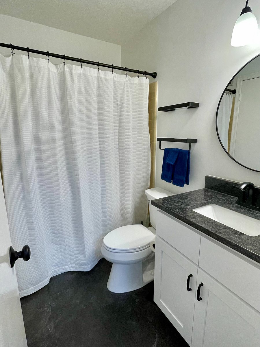 Full bathroom with additional storage closet.