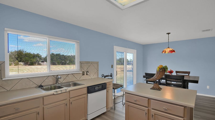 Great view in kitchen with new refrigerator, stove, faucet spray head, equipped with dishes, pots, pans, silverware