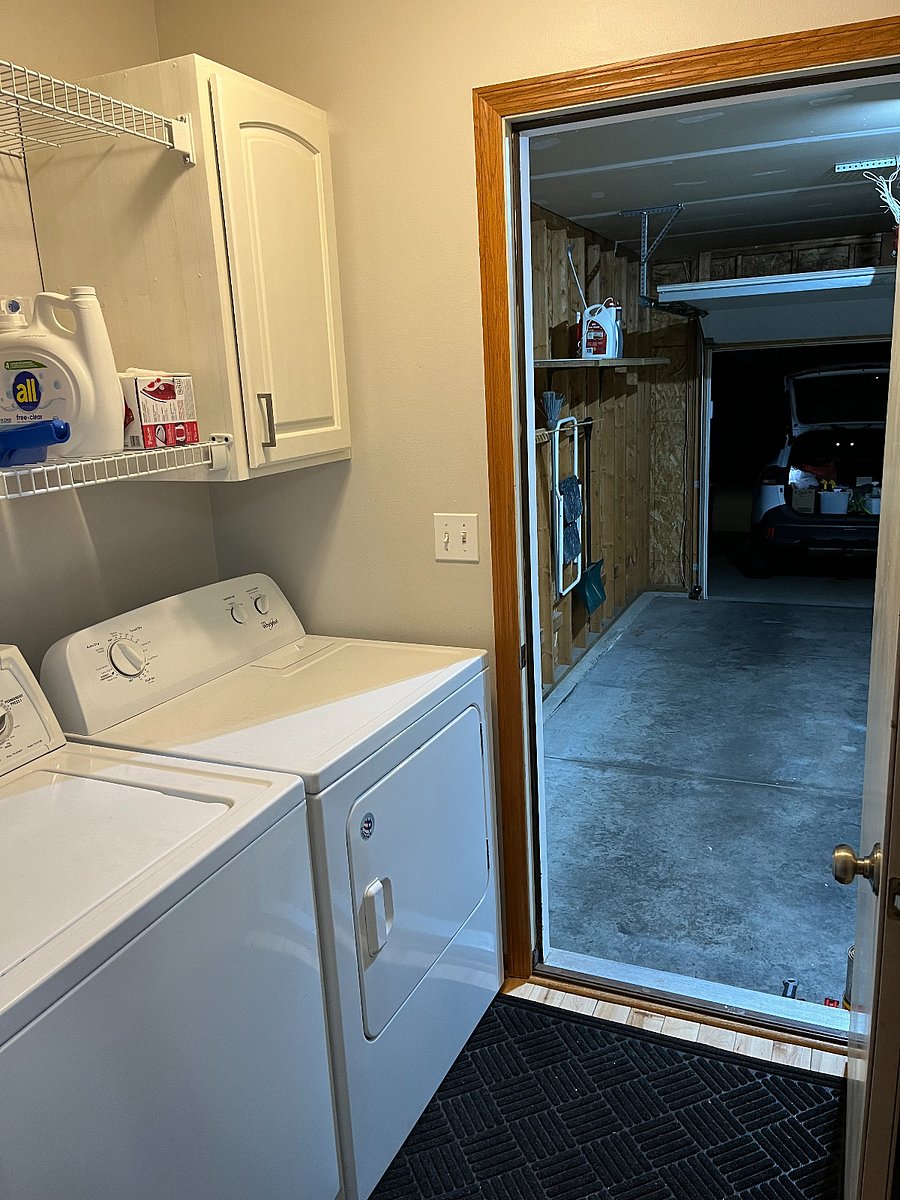 The home has a full size washer and dryer in the transition space from the garage to the kitchen.