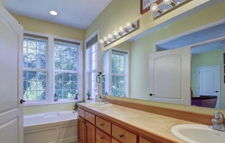 Master bath with soaking tub looking out into forest