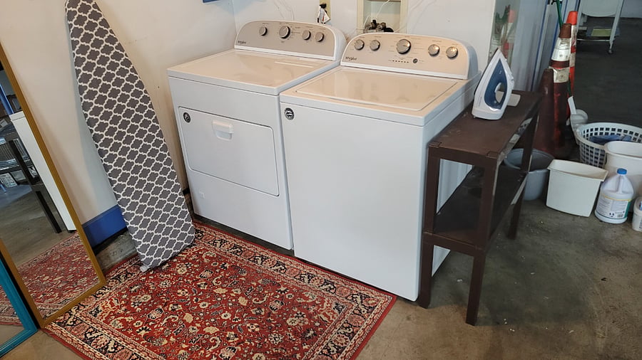Washer and dryer conveniently located in the garage beneath the loft. Includes a full ironing board, iron, and laundry supplies for your convenience.