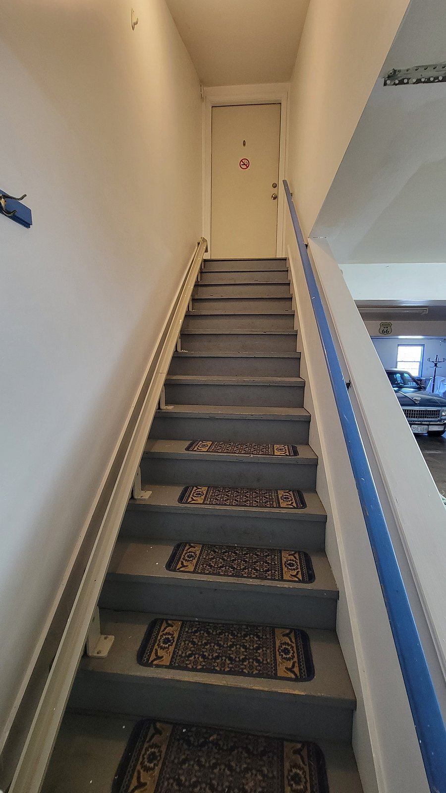 Convenient stairs leading up to the loft entrance from inside the garage, offering easy access to your private space that is protected from the environment.