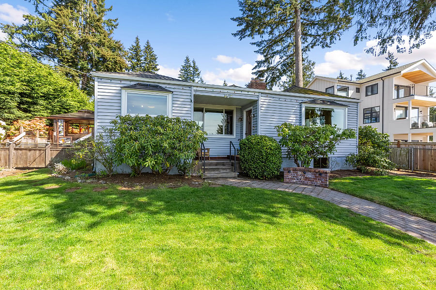 Front of the house from the front yard. Large Rhododendron plants about to bloom for spring