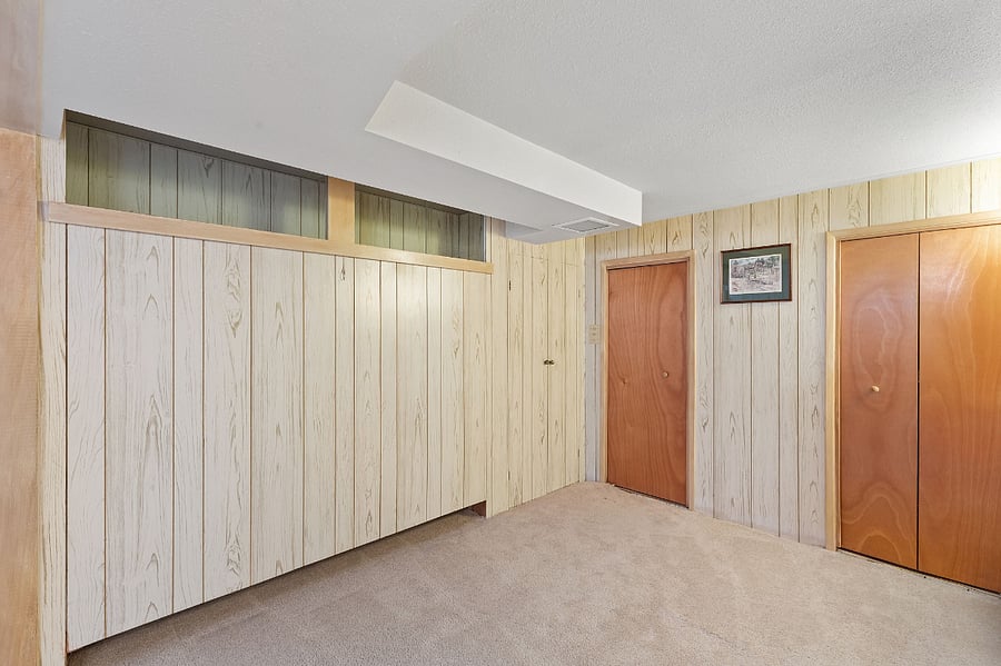 Basement open area with lots of storage and Murphy bed tucked up in the wall