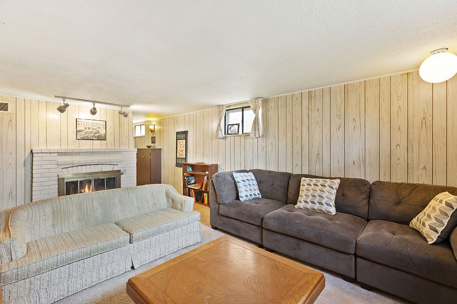 Basement living area with 2 couches, one of which is a super comfortable sectional. Also fireplace
