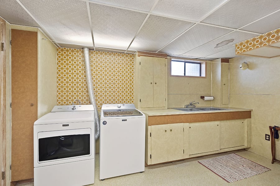 Laundry room with washer/dryer and large, 2 basin concrete utility sink. Tons of storage and amazing 70s design aesthetic