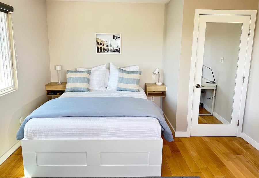 Bedroom 1 with queen size bed and waking closet, full size mirror and desk area