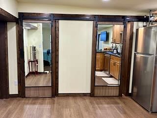 Sliding barn doors to large walkin pantry (on the left) and full bathroom (on the right). 