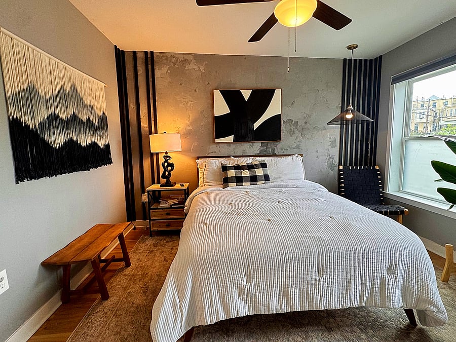 A cloud-soft queen bed, modern wall art, and ambient lighting creating a sanctuary for rest and rejuvenation.