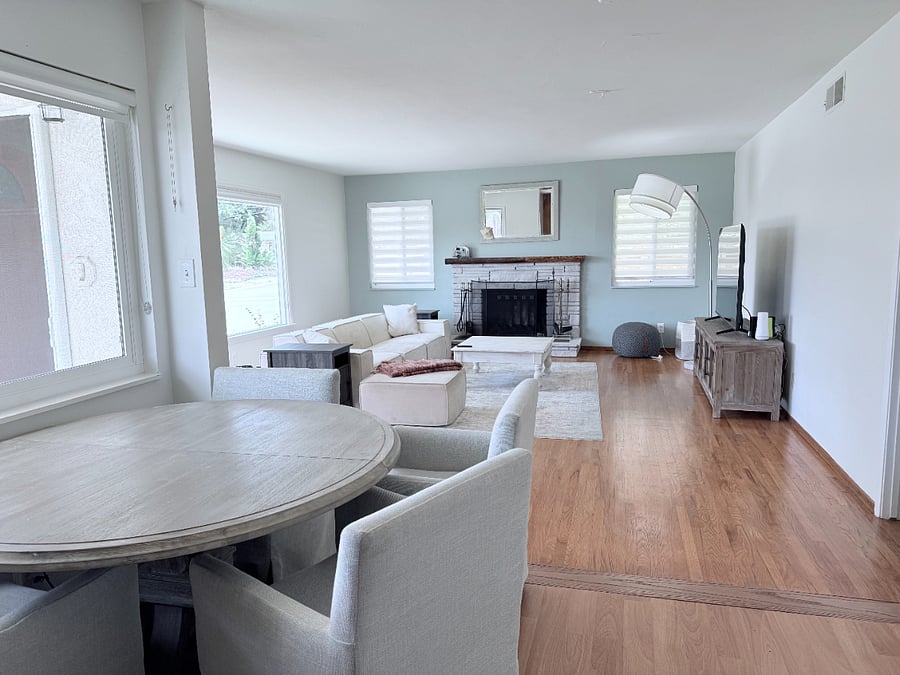 Great room connecting to dining and kitchen. 65 inch TV and a large light filled living room.