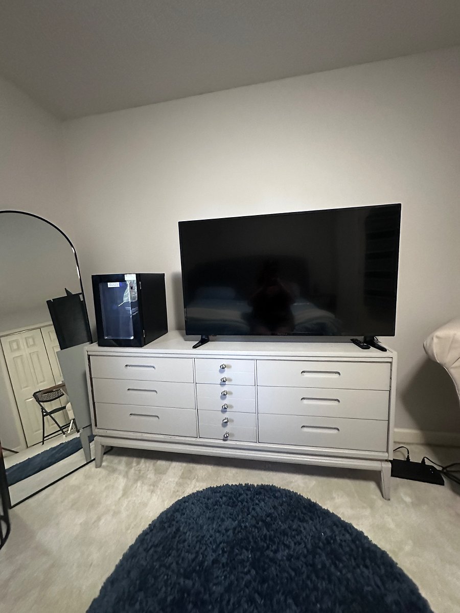 Rental guest bedroom. 50 tv on dresser. Also beverage refrigerator.