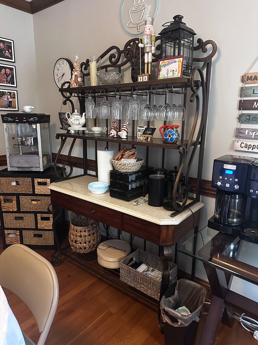 Coffee room with popcorn machine, coffee pods, tea bags, instant oatmeal, hot chocolate packets and extra snacks for you to enjoy. Seating and a table to sit at.