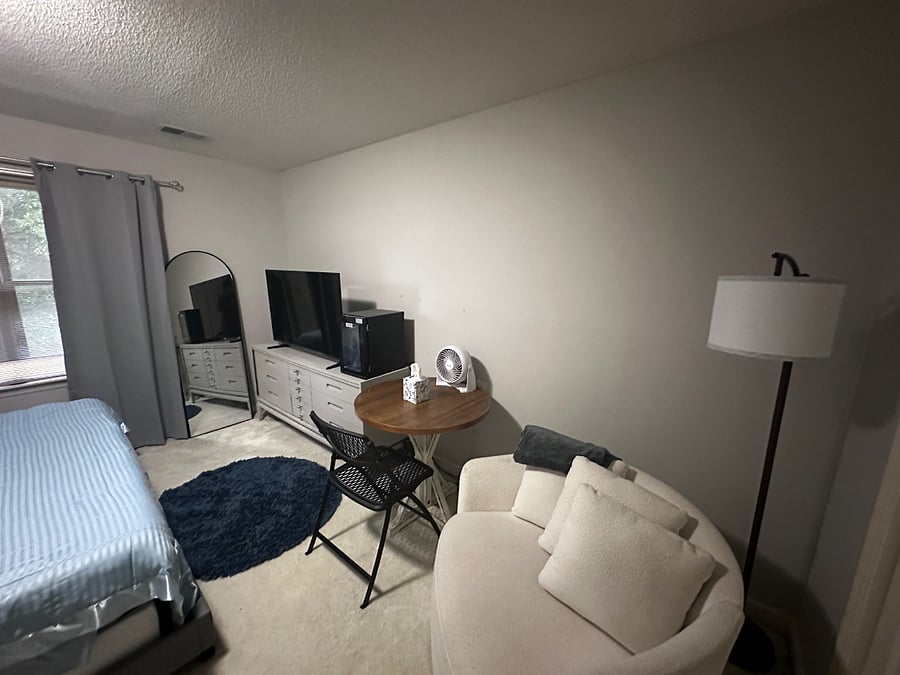 Swivel chair, lamp, 55 TV, beverage fridge and round table and chair.