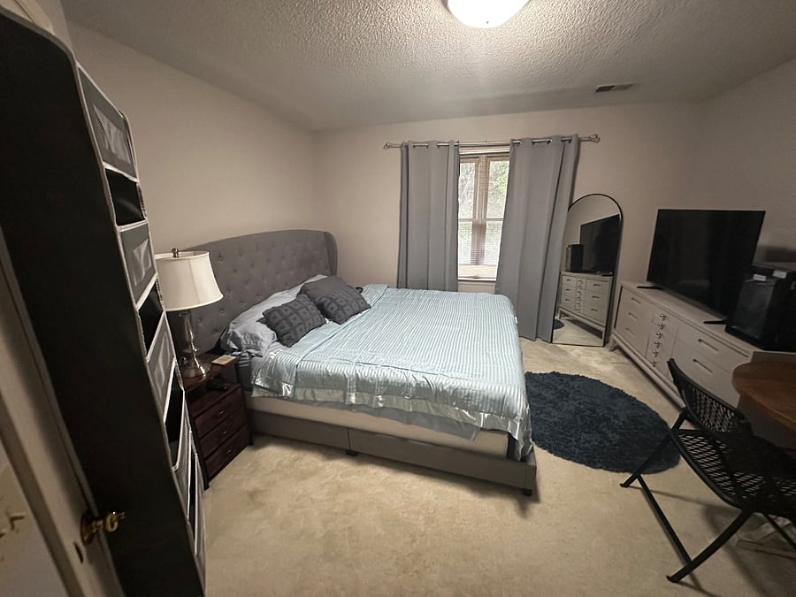 Another view of tenants bedroom showing windows with blackout curtains.