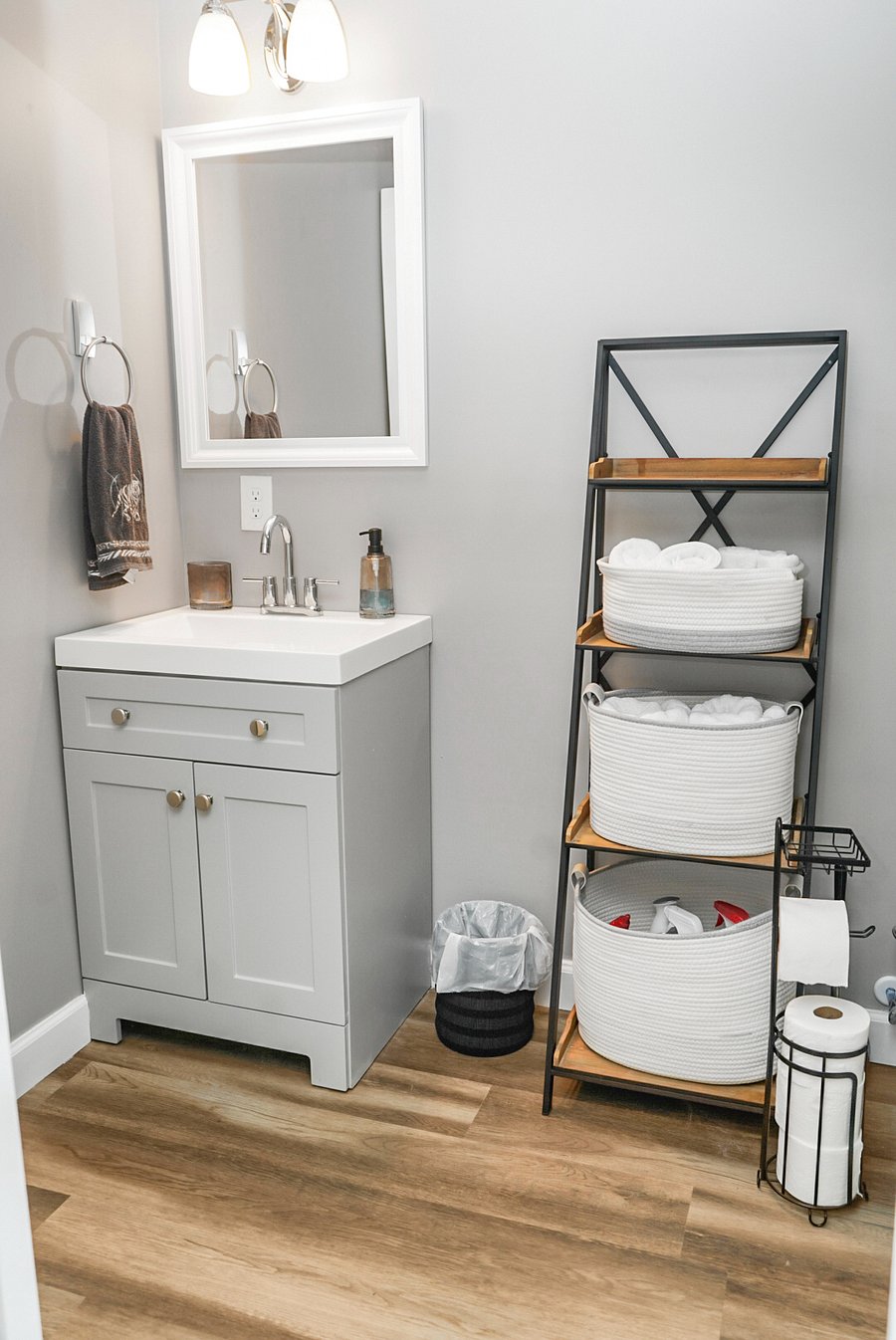 Bright and organized bathroom with modern vanity, open shelving, and neatly arranged essentials for your comfort.