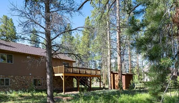 Deck off teh side of the home with grill and stairs/gate 