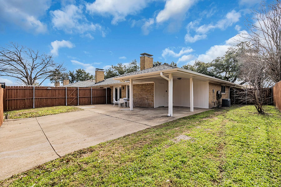 Fully fenced backyard with grassy area