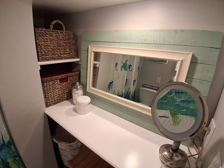 Vanity area with mirror, lighted makeup mirror, vanity stool & blow dryer perfect for getting ready for your day.