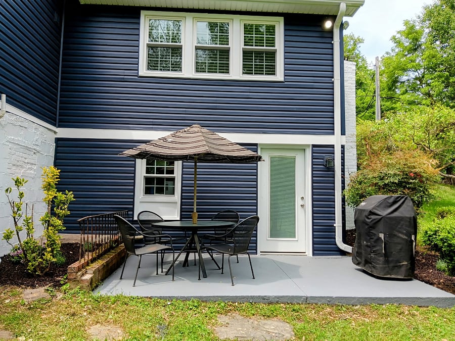 Private patio with outdoor seating and gas grill