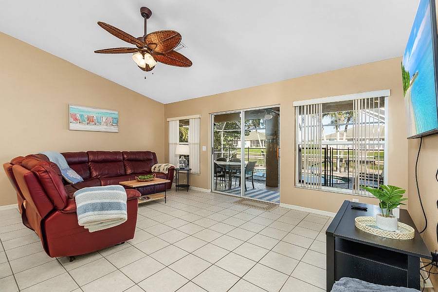 Living room with sliding door to lanai and pool