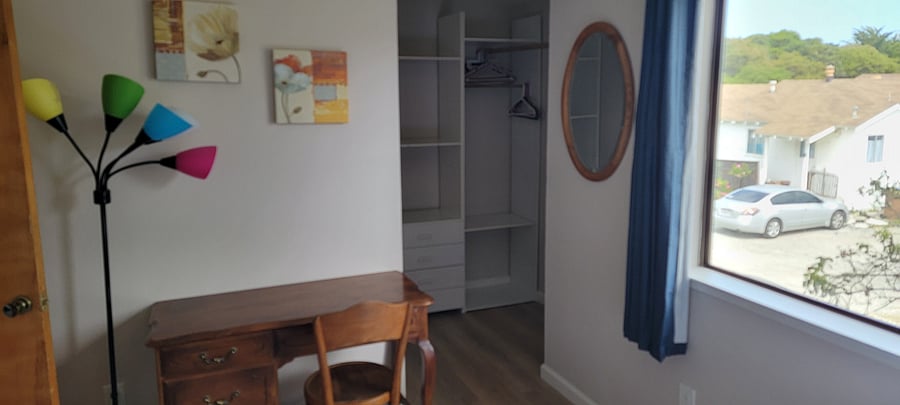 2nd bedroom with desk and walk-in closet