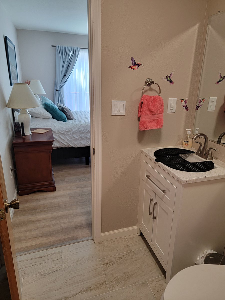 Primary bathroom looking into primary bedroom