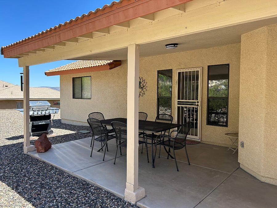 On hot days, the back patio is the coolest place to relax outside. There's seating for six and a propane BBQ grill.