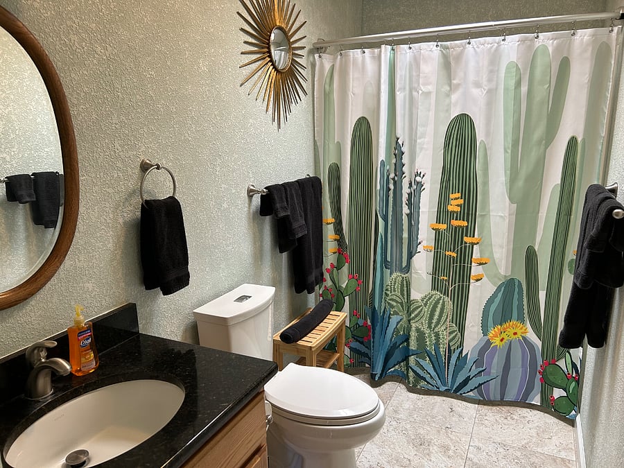 This bathroom is accessed from the hallway and is shared between the two bedrooms at the east end of the home. It includes a skylight, full tub and shower, and linen closet.
