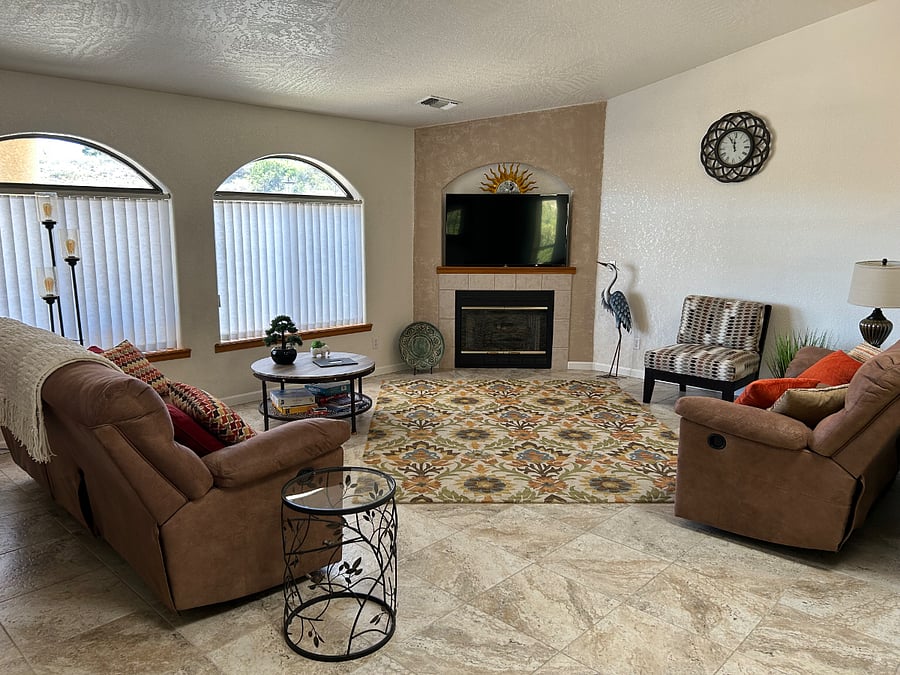 The living room has comfortable furniture that reclines. A great place to watch the hummingbirds feed above the bed of roses.