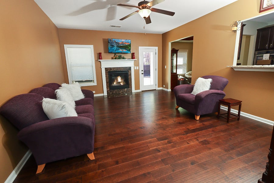 Make yourself at home in the spacious living room, where cozy sofas and a charming fireplace create the perfect spot to unwind and relax.