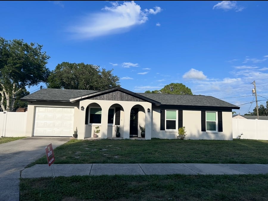 Welcome to your Sarasota home-away-from-home with garage and lush landscaping.